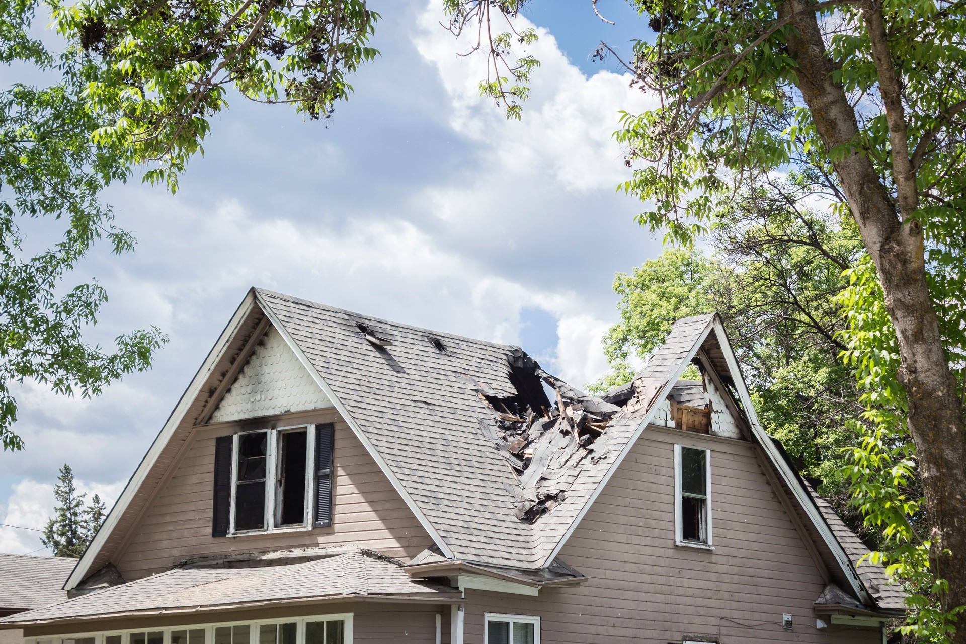 roof of a house burned and caved in.